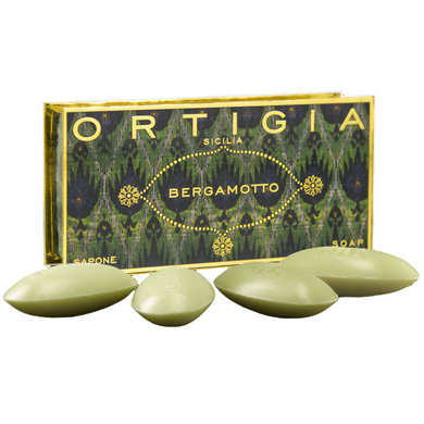 Green soap bars with 'Ortigia' packaging on a white background