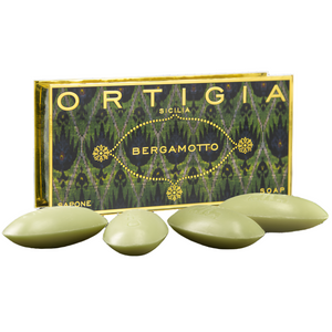 Green soap bars with 'Ortigia' packaging on a white background