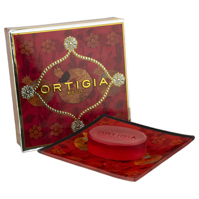 Red soap with decorative packaging featuring 'Ortigia' branding on a white background