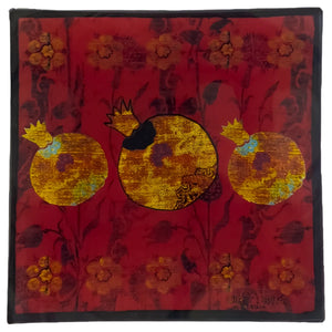 Decorative piece with pomegranate design on a red background